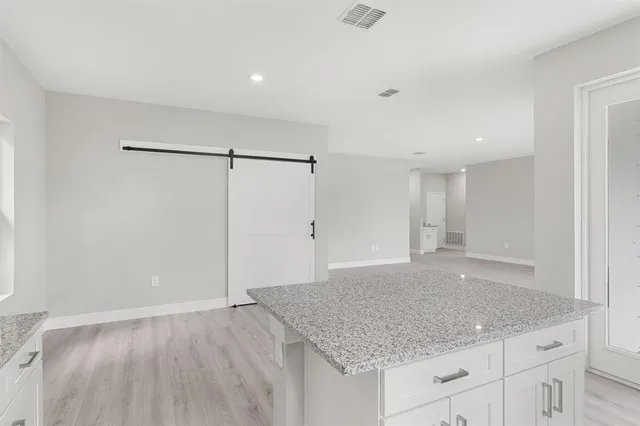 a kitchen with stainless steel appliances granite countertop a sink a stove and a granite counter tops