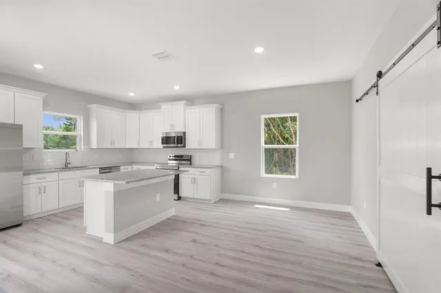 a kitchen with a white cabinets and stainless steel appliances