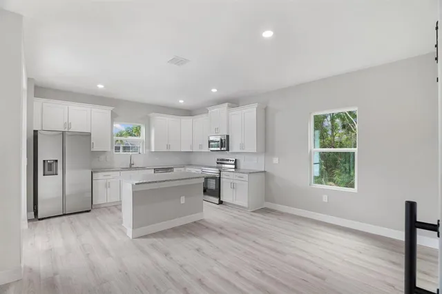 a view of a kitchen with wooden floor