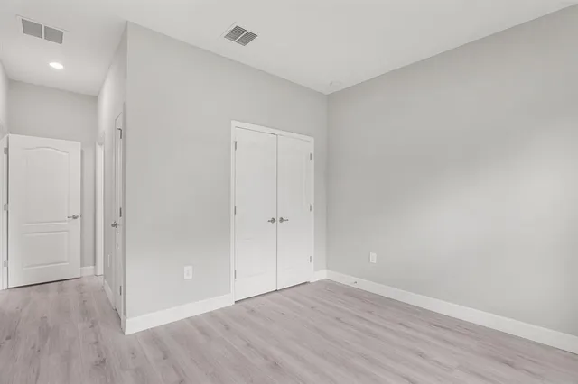 a bathroom with a granite countertop sink and mirror with toilet