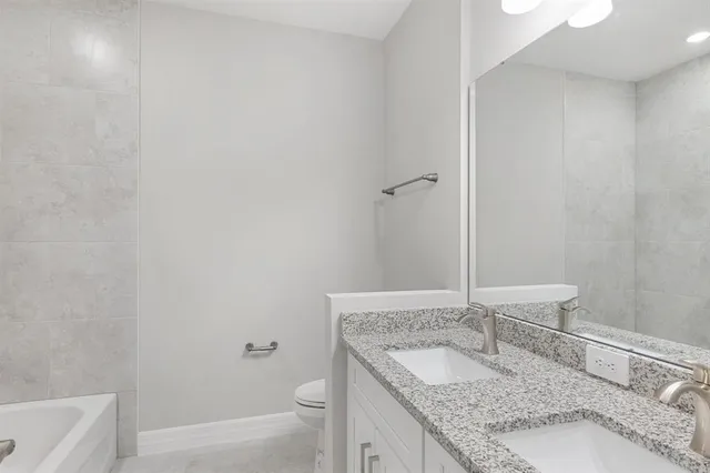 a bathroom with a toilet a sink and a bathtub