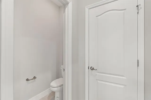 a bathroom with a granite countertop double vanity sink and mirror