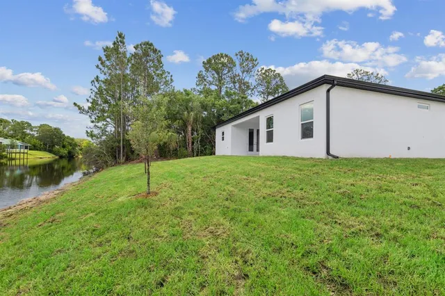 an aerial view of residential houses with outdoor space and trees