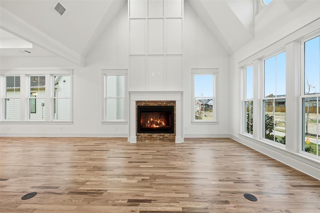 321 Garrett Way Midlothian, TX 76065 - Photo 11 of 28 a view of an empty room with window and wooden floor