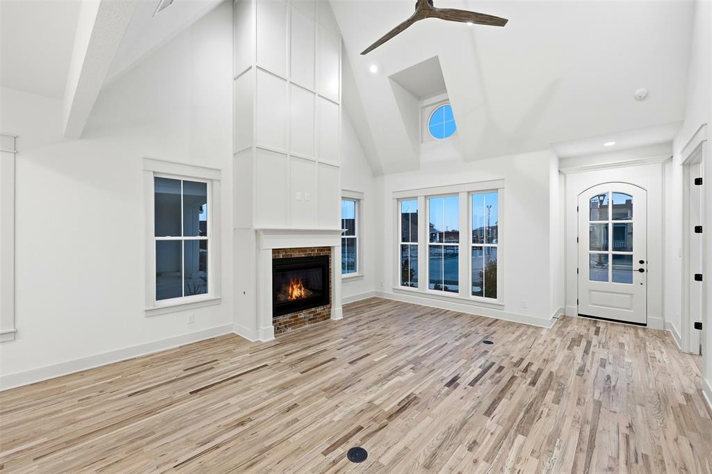 321 Garrett Way Midlothian, TX 76065 - Photo 12 of 28 an empty room with wooden floor and fireplace