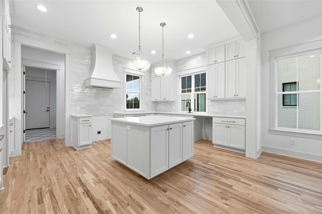 321 Garrett Way Midlothian, TX 76065 - Photo 15 of 28 a kitchen with white cabinets stainless steel appliances and a fireplace