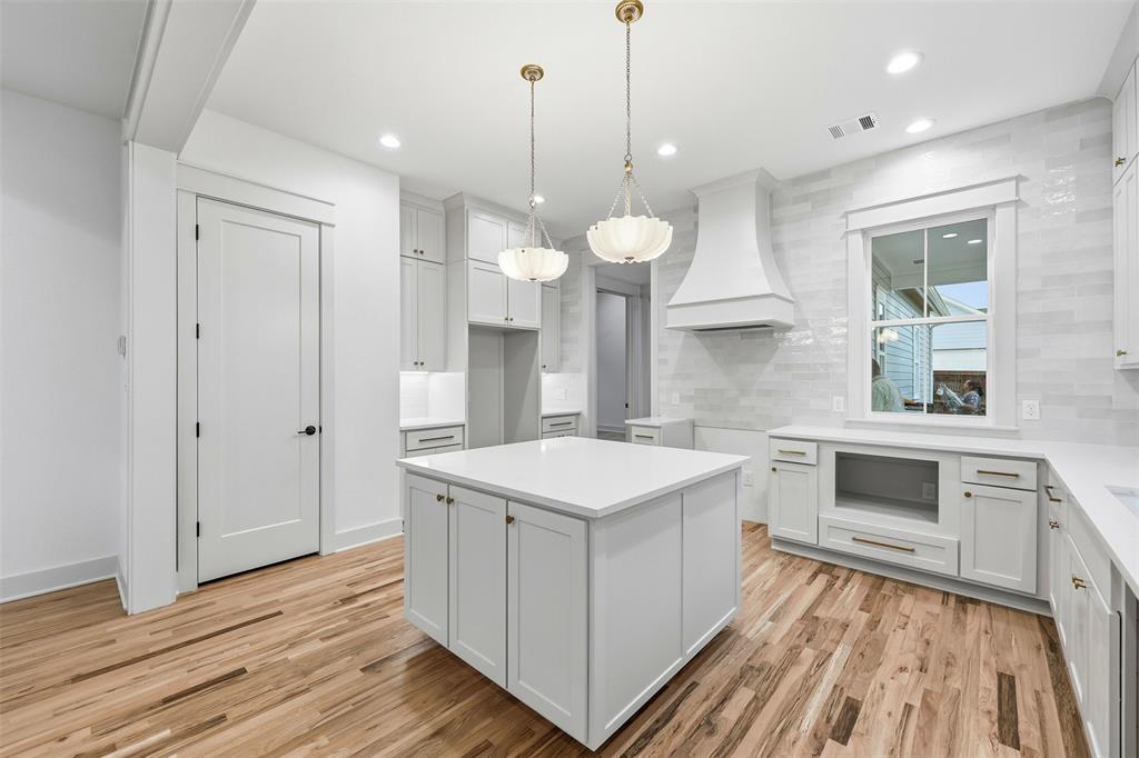 321 Garrett Way Midlothian, TX 76065 - Photo 17 of 28 a kitchen with a stove a sink and wooden floor