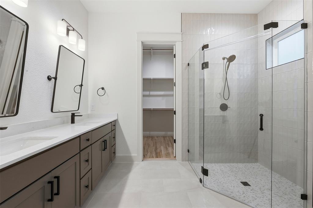 321 Garrett Way Midlothian, TX 76065 - Photo 19 of 28 a bathroom with a shower sink and mirror