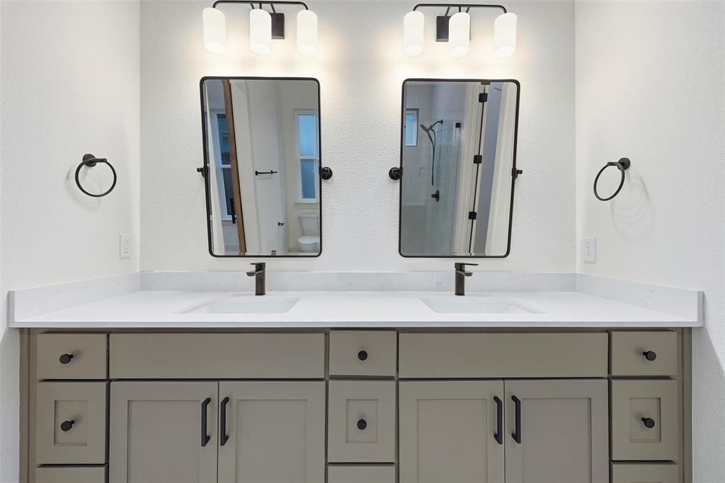 321 Garrett Way Midlothian, TX 76065 - Photo 23 of 28 a bathroom with double vanity sinks and a shower