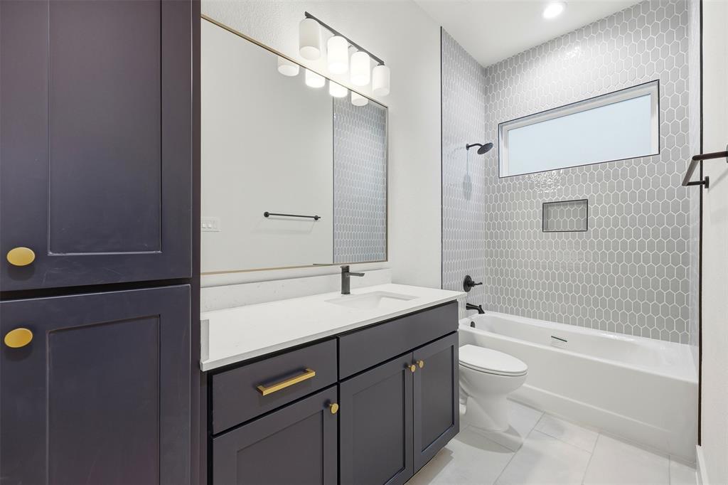 321 Garrett Way Midlothian, TX 76065 - Photo 25 of 28 a bathroom with a bathtub shower sink vanity granite and toilet