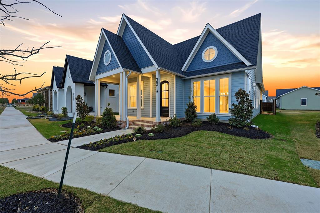 321 Garrett Way Midlothian, TX 76065 - Photo 3 of 28 a front view of a house with garden