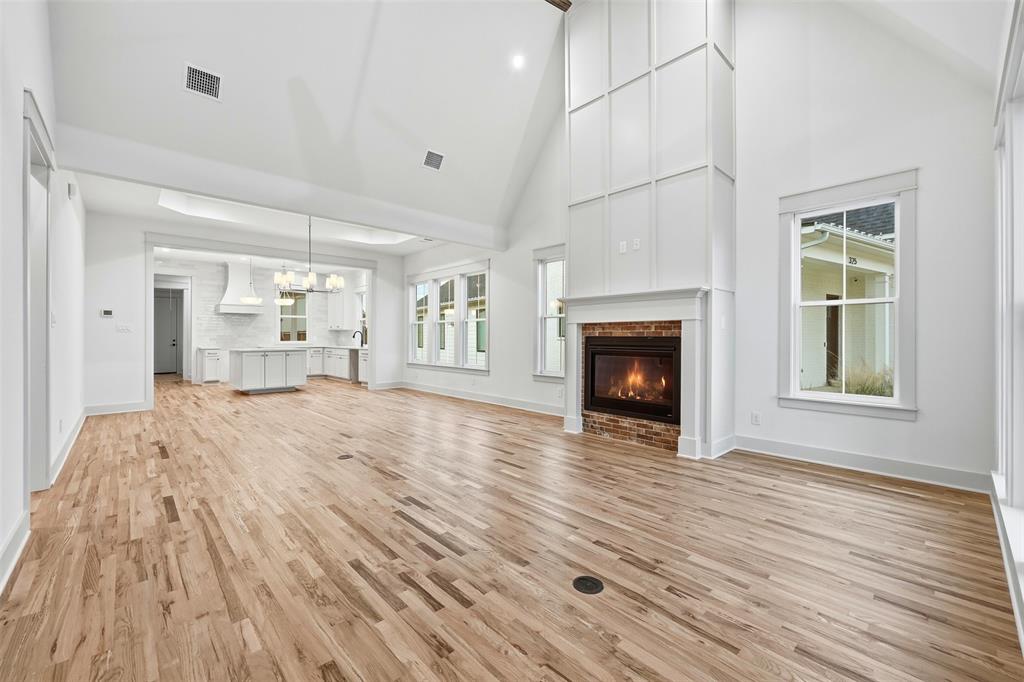 321 Garrett Way Midlothian, TX 76065 - Photo 4 of 28 a view of a livingroom with wooden floor and a fireplace
