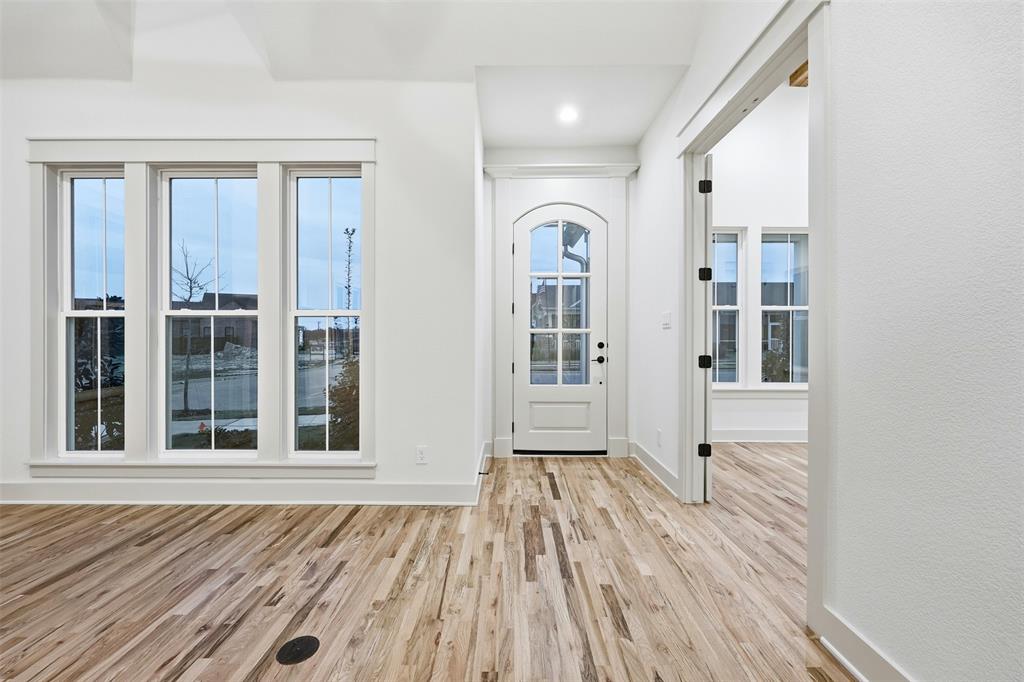 321 Garrett Way Midlothian, TX 76065 - Photo 8 of 28 wooden floor in an empty room with a window