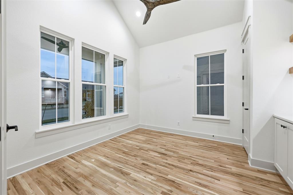 321 Garrett Way Midlothian, TX 76065 - Photo 9 of 28 a view of an empty room with wooden floor and a window