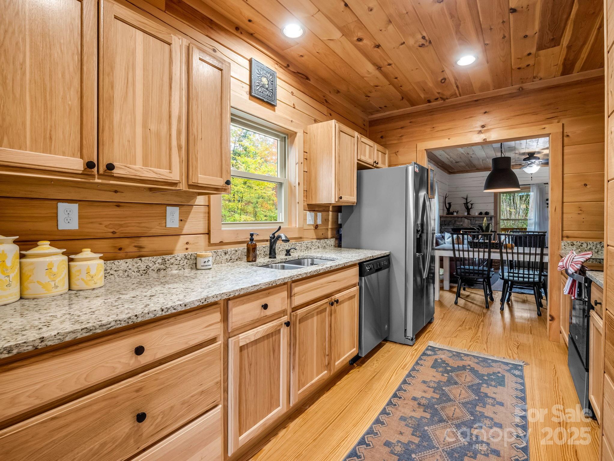 174 Doves Way Lake Lure, NC 28746 - Photo 11 of 42 a kitchen with granite countertop lots of counter top space and stainless steel appliances