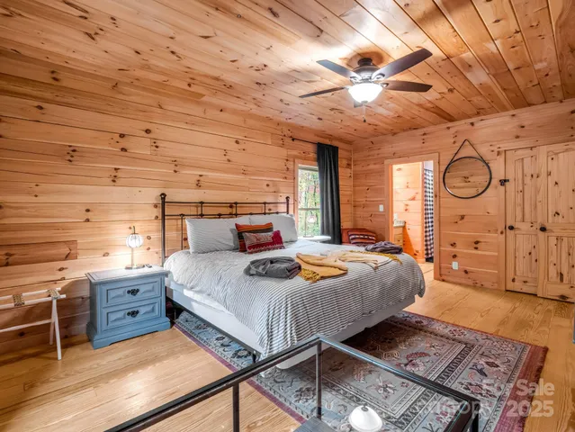 a bed room with a bed and a ceiling fan