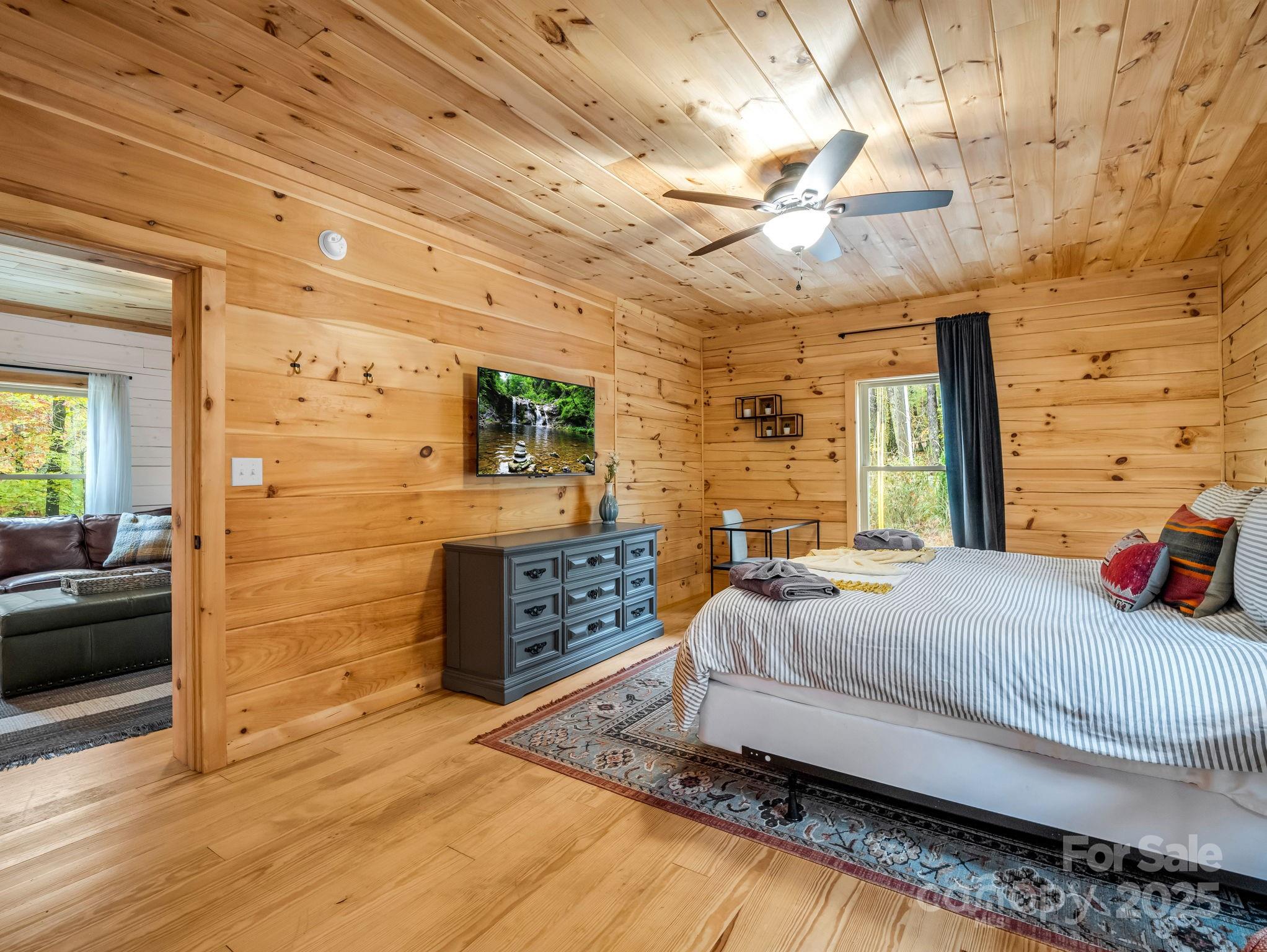 174 Doves Way Lake Lure, NC 28746 - Photo 14 of 42 a bedroom with a bed and wooden floor