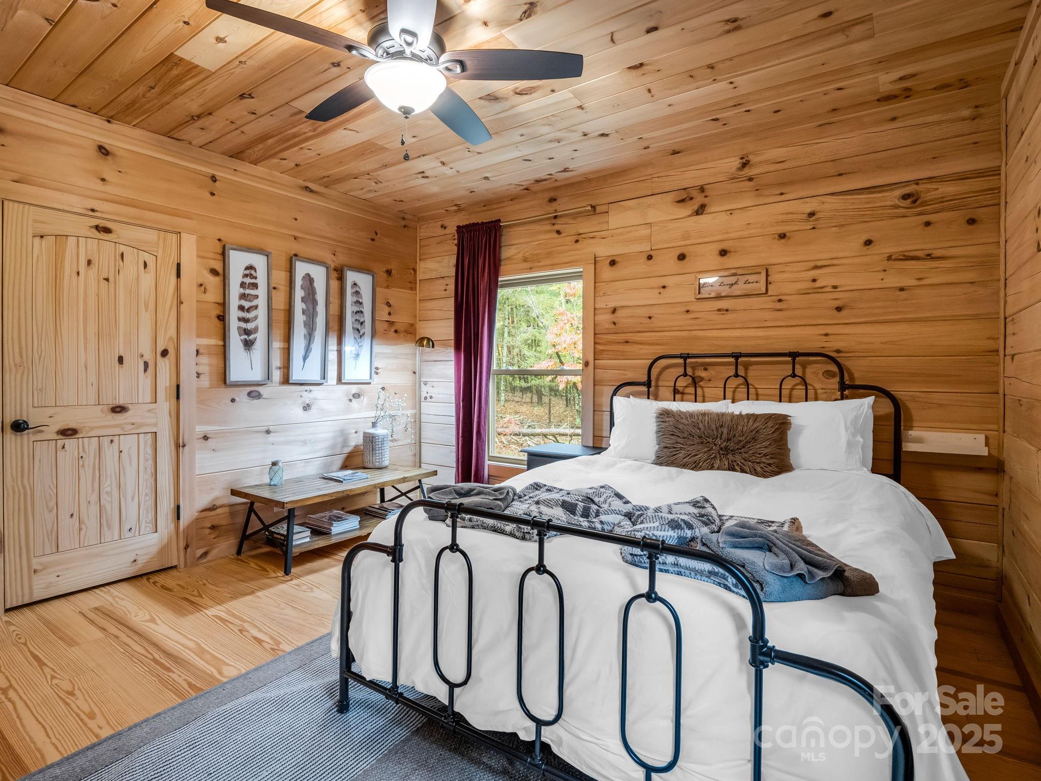 174 Doves Way Lake Lure, NC 28746 - Photo 19 of 42 a bed room with furniture and wooden floor