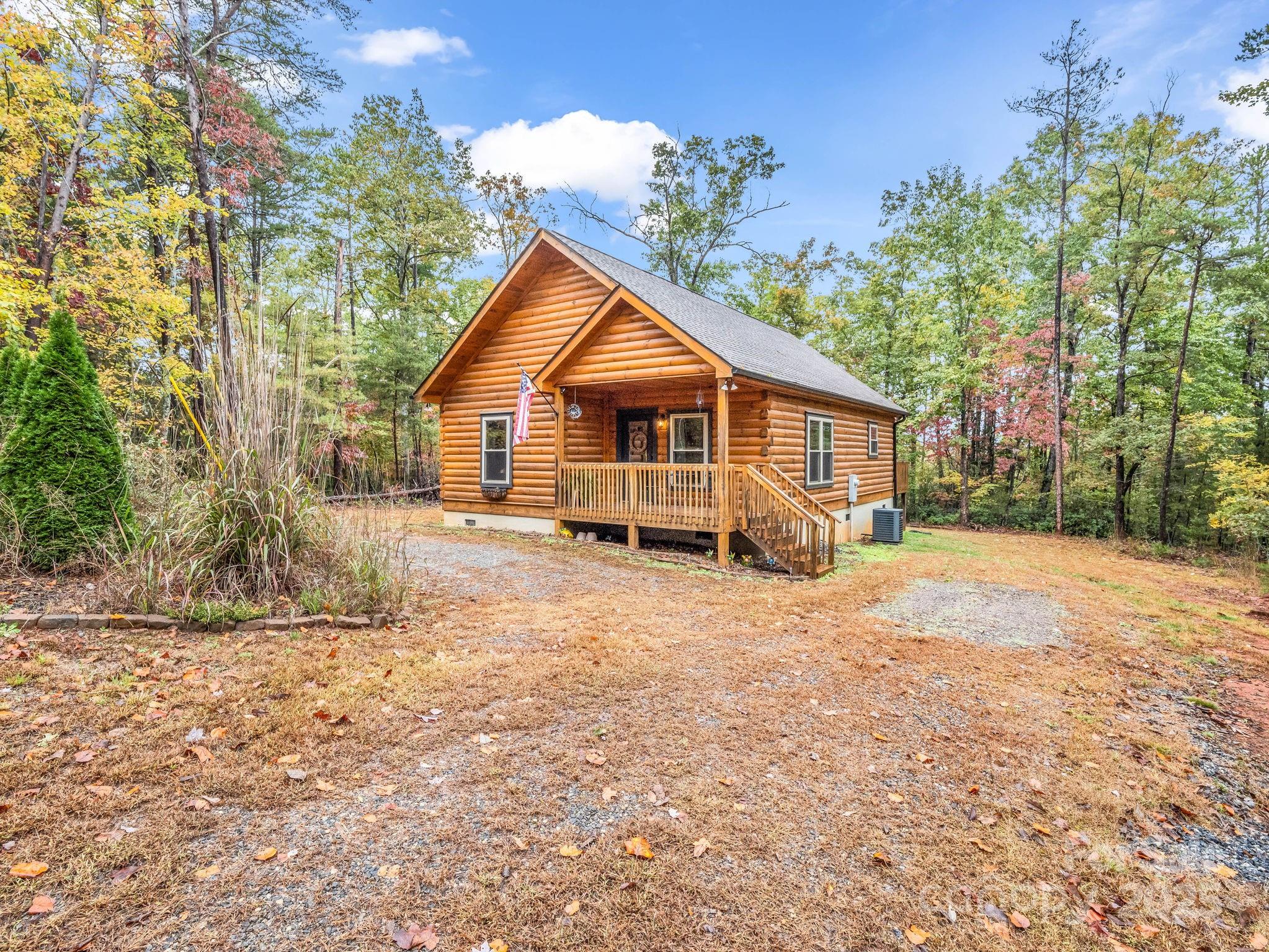 174 Doves Way Lake Lure, NC 28746 - Photo 21 of 42 a view of a house with a yard covered in the forest