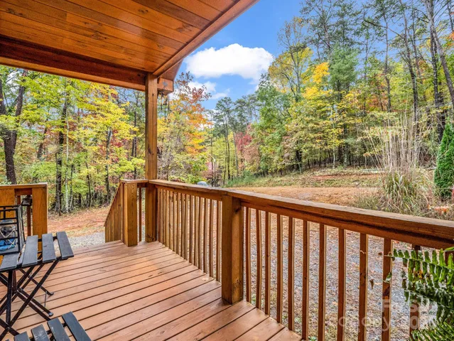 a view of balcony with wooden floor and fence