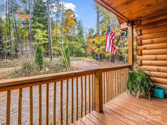a view of a balcony with wooden floor and fence