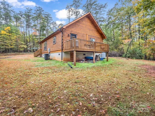 a view of a house with a yard and sitting area