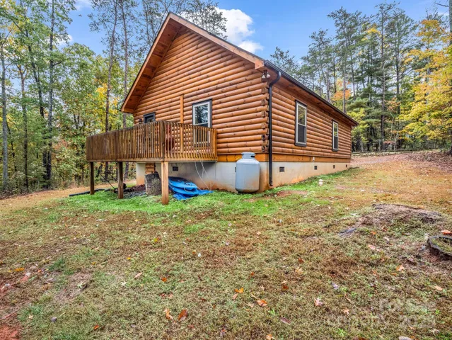 a view of a house with a yard and sitting area