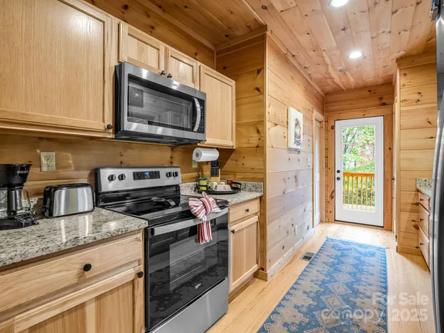 a kitchen with stainless steel appliances granite countertop a stove and a microwave