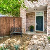 a view of a house with a wooden fence