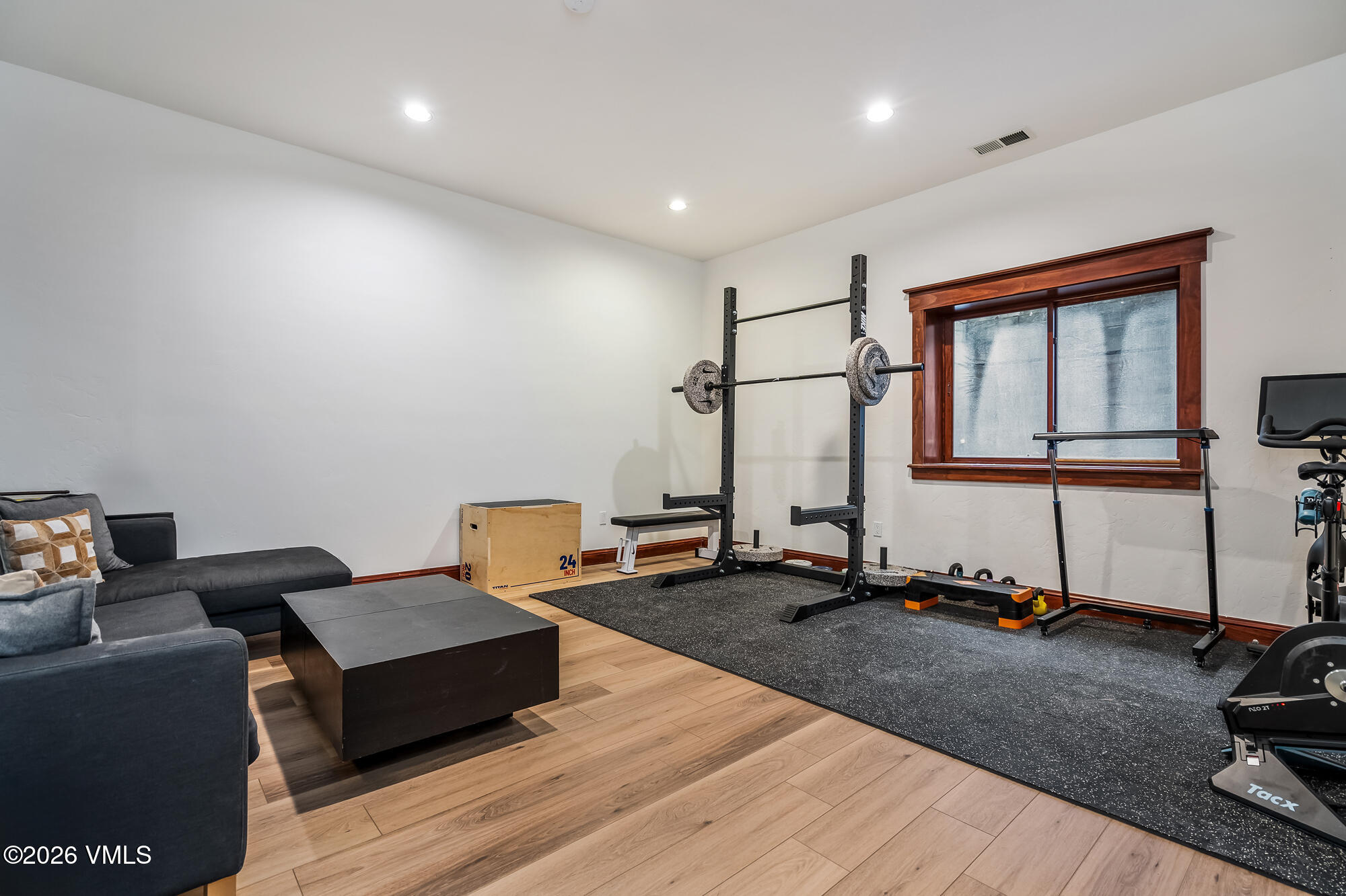 32 Newquist Street Eagle, CO 81631 - Photo 29 of 57 a living room with furniture gym equipment and a wooden floor