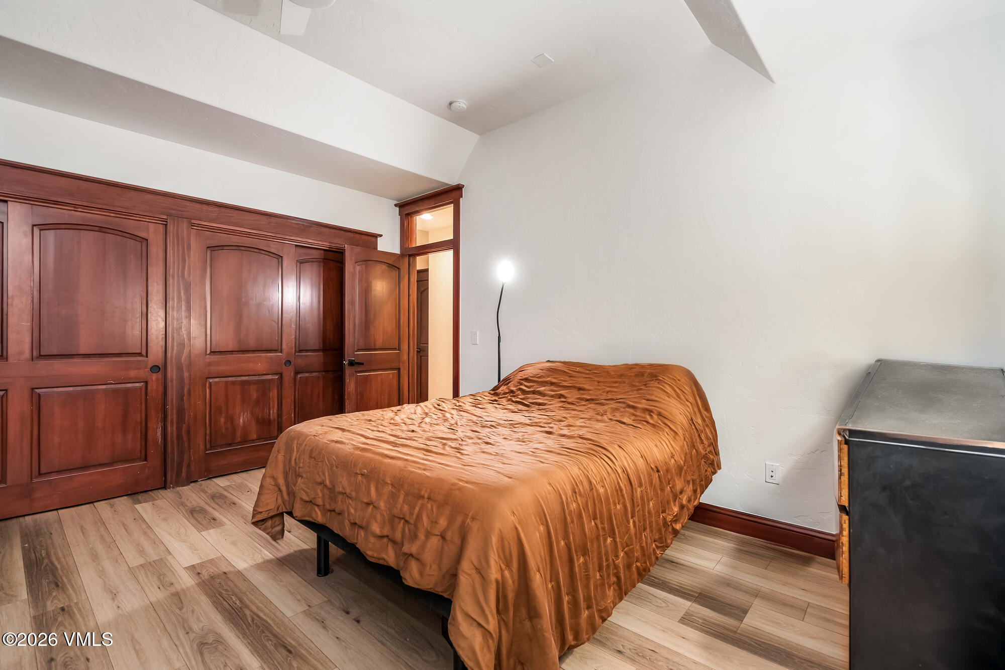 32 Newquist Street Eagle, CO 81631 - Photo 36 of 57 a bedroom with a bed and wooden floor