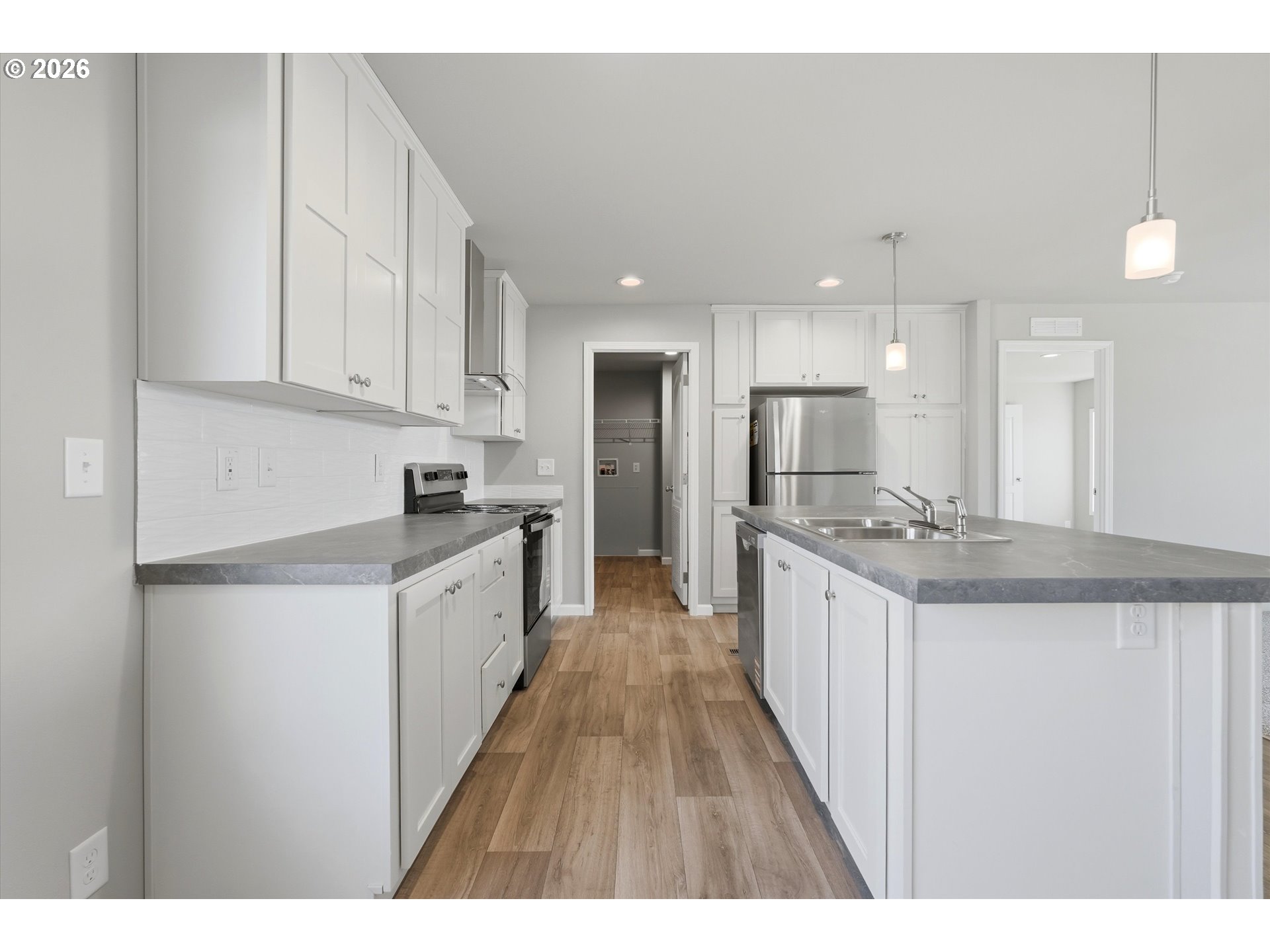 412 Rosedell Street Amity, OR 97101 - Photo 13 of 38 a large kitchen with kitchen island granite countertop a large counter top and stainless steel appliances