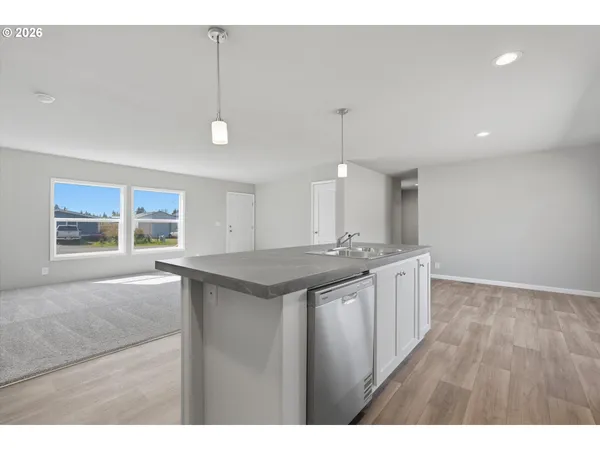 a kitchen with granite countertop a stove sink and cabinets