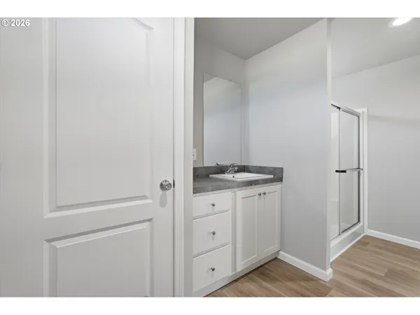 a bathroom with a granite countertop sink toilet a large mirror a bathtub and shower
