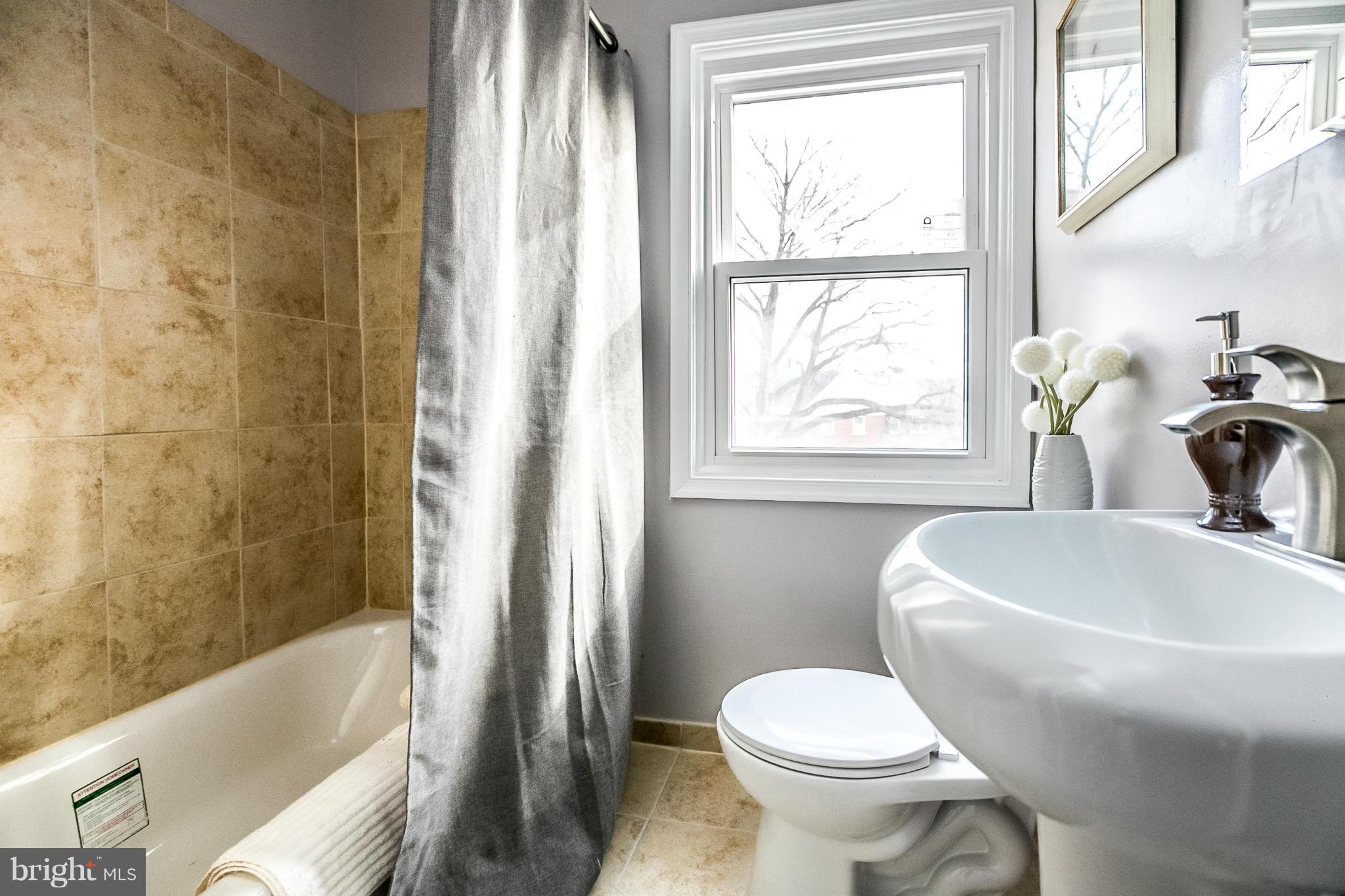 8632 Rock Oak Road Baltimore, MD 21234 - Photo 14 of 30 a bathroom with a sink toilet and bathtub