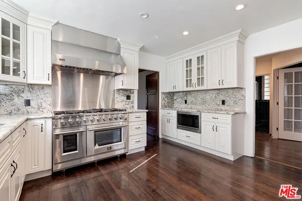 a kitchen with a stove oven and sink