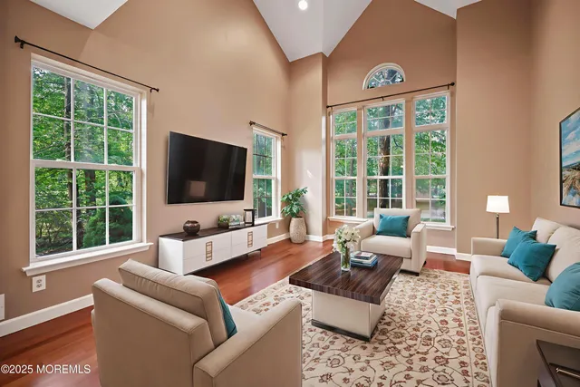 a living room with furniture tv and large window