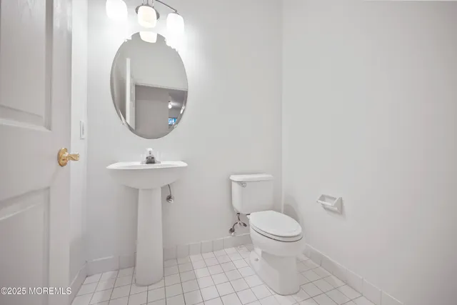 wooden floor in an empty room with a chandelier