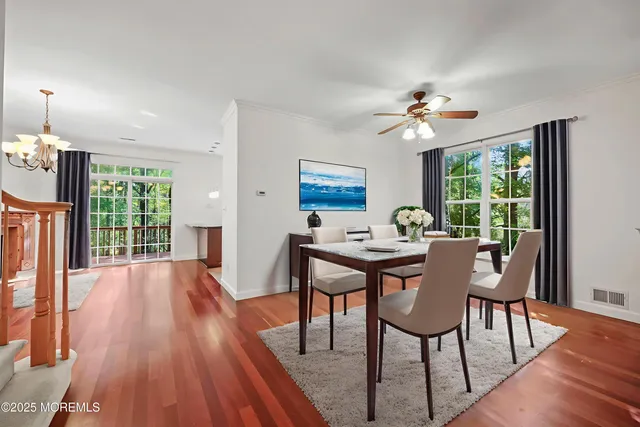 a view of empty room with wooden floor fireplace and window