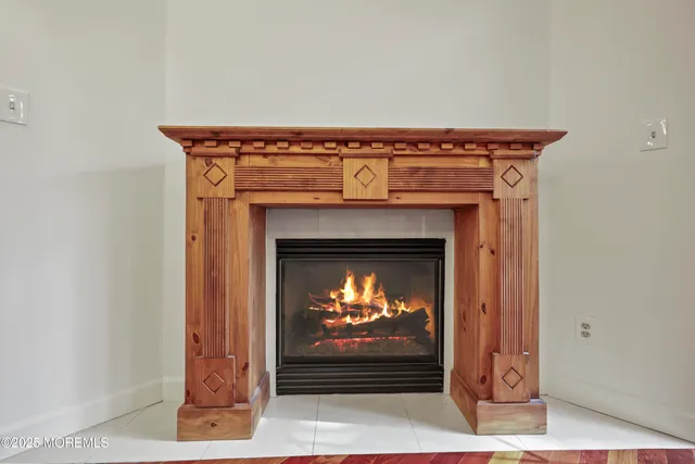 a kitchen with stainless steel appliances granite countertop a refrigerator a sink dishwasher a stove and a dining table with wooden floor