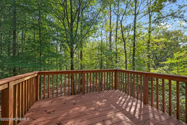 a view of a balcony with a floor to ceiling window and wooden fence