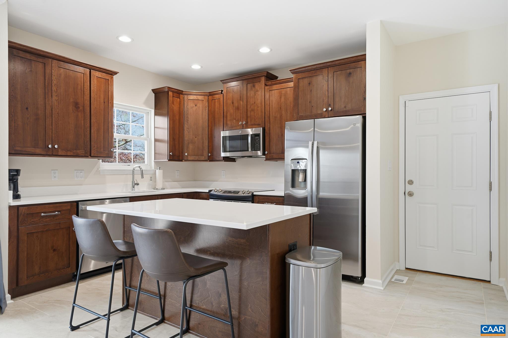 6518 Jefferson Mill Road Scottsville, VA 24590 - Photo 34 of 60 a kitchen with stainless steel appliances granite countertop a refrigerator a sink a stove a microwave and island with wooden cabinets