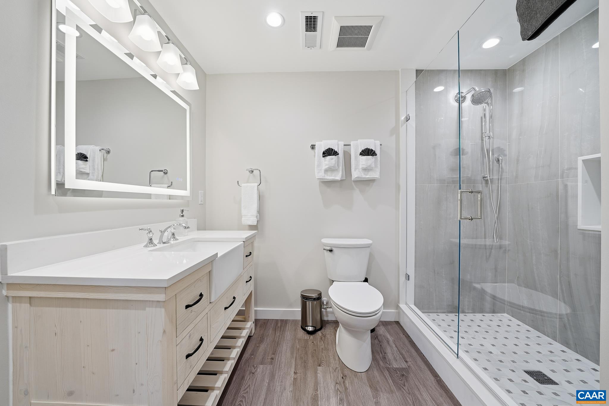 6518 Jefferson Mill Road Scottsville, VA 24590 - Photo 42 of 60 a bathroom with a sink a toilet a mirror and shower