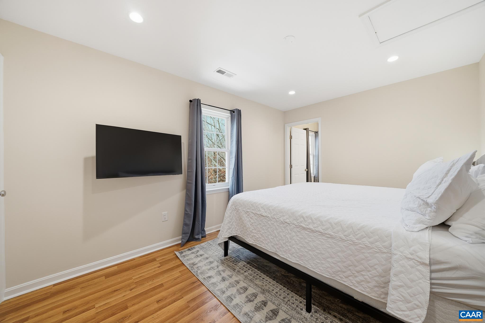 6518 Jefferson Mill Road Scottsville, VA 24590 - Photo 46 of 60 a bedroom with a bed and a flat screen tv