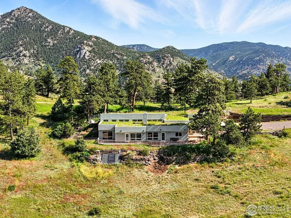 a view of a house with a mountain in the background