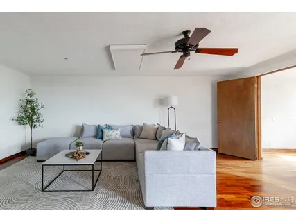 a living room with furniture a rug and a painting on the wall