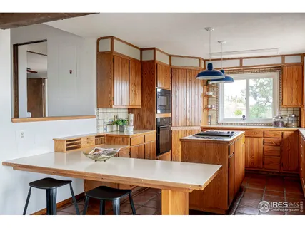 a view of an empty room with wooden floor and closet