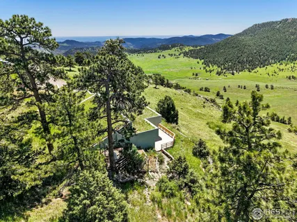 a view of a house with a flower garden