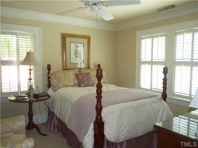 2238 The Circle Raleigh, NC 27608 - Photo 14 of 23 a bed room with a bed and a chandelier