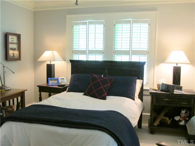 2238 The Circle Raleigh, NC 27608 - Photo 15 of 23 a bedroom with a bed and a lamp